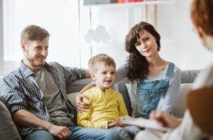 A family sitting on the couch learning about healthy co-parenting