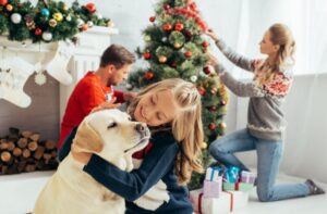 A family decorating a Christmas tree, contemplating whether divorced parents should spend holidays together?