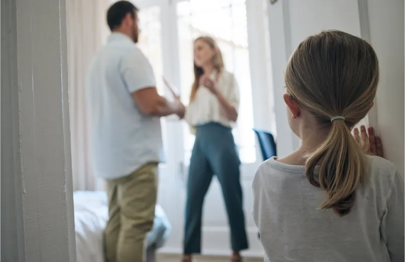 Little girl watching her parents argue at home.